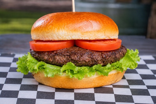 American Classic Hamburger with lettuce and tomato on a brioche bun