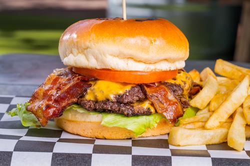 Bacon Cheeseburger stacked with crispy bacon, lettuce and tomato