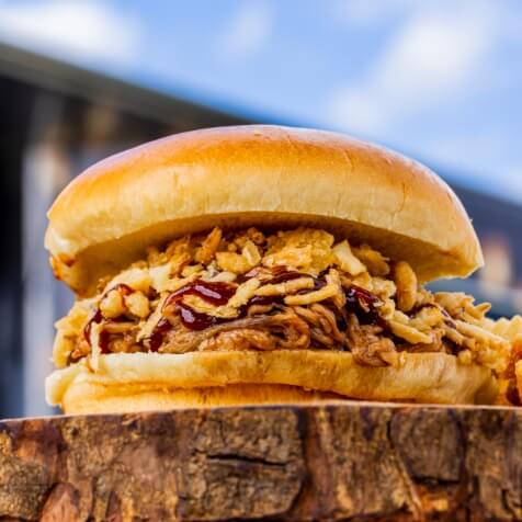 Pulled Pork Sandwich topped with crispy onions