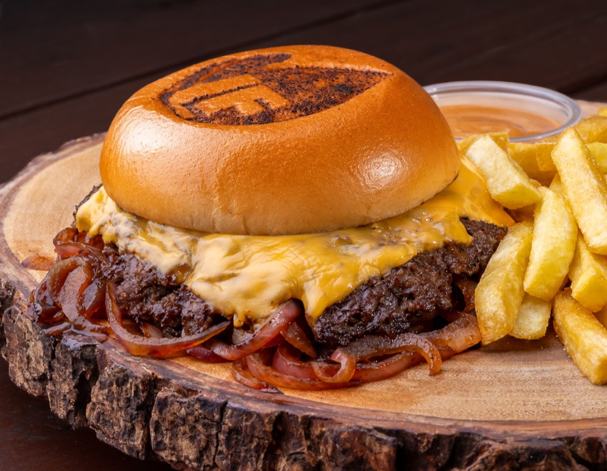 Smashed Oklahoma Burger with caramelized onions, served with fries