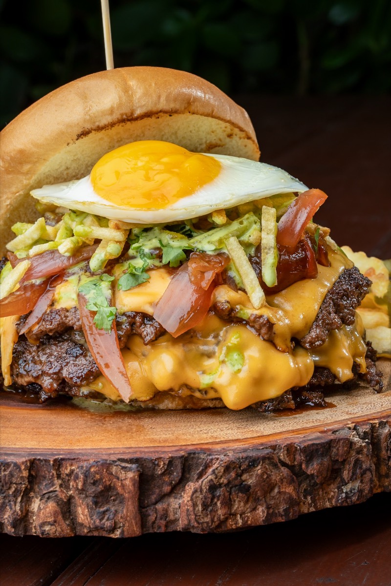 Smashed with All The Fixin's Burger crowned with a fried egg